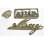 THREE SILVER BROOCHES Comprising a paste set 'May' brooch, a five cherubs at play rectangular