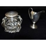 A VICTORIAN SILVER HELMET SHAPED CREAM JUG The small jug on pedestal base 10cms high, hallmarked