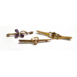 THREE 9CT GOLD BAR BROOCHES Comprising a garnet set, an amethyst set and a plain heart design, one