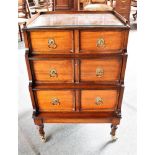 LOW MAHOGANY TWO DRAWER UNIT, in three graduating tiers, on circular supports with casters, 69cm x