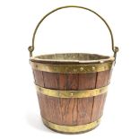 19TH CENTURY OAK AND BRASS MOUNTED BUCKET, with brass carrying handle, 28cm high, 34cm diameter