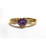 A HEART SHAPED AMETHYST SET 9CT GOLD RING with diamond set twist shoulders, size O, gross weight