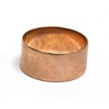 A HALLMARKED 9CT ROSE GOLD PLAIN WEDDING BAND Of flat section 9mm wide, size R, weighing approx. 4.1