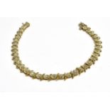 A 9CT GOLD DIAMOND LINE BRACELET thirty four small diamonds with a total weight of 0.96 carats