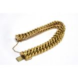 A 9CT GOLD FANCY LINK BRACELET the diagonal plain faceted curb link to patterned link borders with