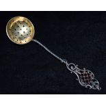 A CONTINTENTAL SILVER SIFTING LADLE The lattice work top with red and green glass plique a jour