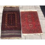 A BLUE GROUND PRAYER RUG 81cm x 144cm; and another small red ground rug 81cm x 107cm (2)