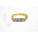 A DIAMOND THREE STONE 18CT GOLD RING the three round brilliant cut diamonds, weighing a total of