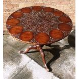 MAHOGANY CIRCULAR PEDESTAL TABLE, the top with a carved centre floral decoration, with a twelve