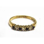 A DIAMOND AND SAPHIRE SET 9CT GOLD RING The single row front comprising 3 small round cut diamonds