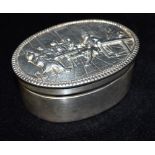 A GEORGIAN SILVER TOBACCO BOX The oval box with embossed tavern scene of pipe smokers to hinged lid,