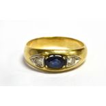 A SAPPHIRE AND DIAMOND THREE STONE RING The central opal cut sapphire with two small diamonds, one