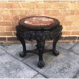 A CHINESE CARVED HARDWOOD PLANTSTAND with marble inset top, 44cm diameter, 45cm high Condition