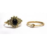 TWO DIAMOND SET 9CT GOLD RINGS Comprising a sapphire and diamond cluster, the oval sapphire with