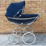 A MARMET (BY BRITAX) PRAM the lined navy blue metal body fitted with a folding hood and apron, on