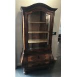 19TH CONTINENTAL BOMBE WALNUT DISPLAY CABINET, the domed top above a glazed door opening to reveal