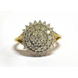 A DIAMOND MULTI-TEIR CLUSTER 9CT GOLD RING the small round brilliant cut diamonds weighing a total