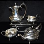 A SILVER FOUR PIECE TEASET BY EDWARD VINER Of oval plain faceted design with pear shaped hot water