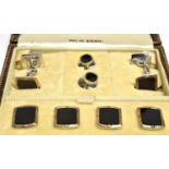 A BOXED SET OF ONYX SILVER AND 14CT GOLD DRESS STUDS The cushion shaped set comprising chain