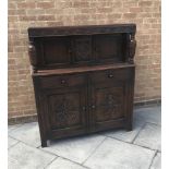 CARVED OAK COURT CUPBOARD, the upper section having a central carved panel flanked by two doors,