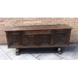 AN OAK SIDE CABINET, the central section having a drawer above a pair of twin cupboard doors,