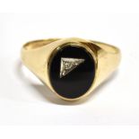 A GENTS ONYX 9CT GOLD SIGNET RING The oval onyx head inset with a very small diamond to a hallmarked