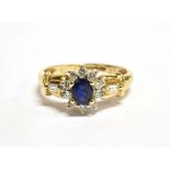A SAPPHIRE AND DIAMOND OVAL CLUSTER RING the central oval cut sapphire approx. 5 x 4mm weighing