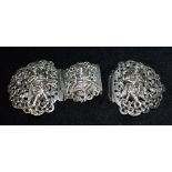 AN INDIAN SILVER BELT BUCKLE The three section buckle each with an embossed figure of a deity, 15