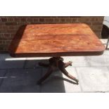 MAHOGANY TILT TOP TABLE, raised on central column with four splayed legs raised on casters, 73cm x