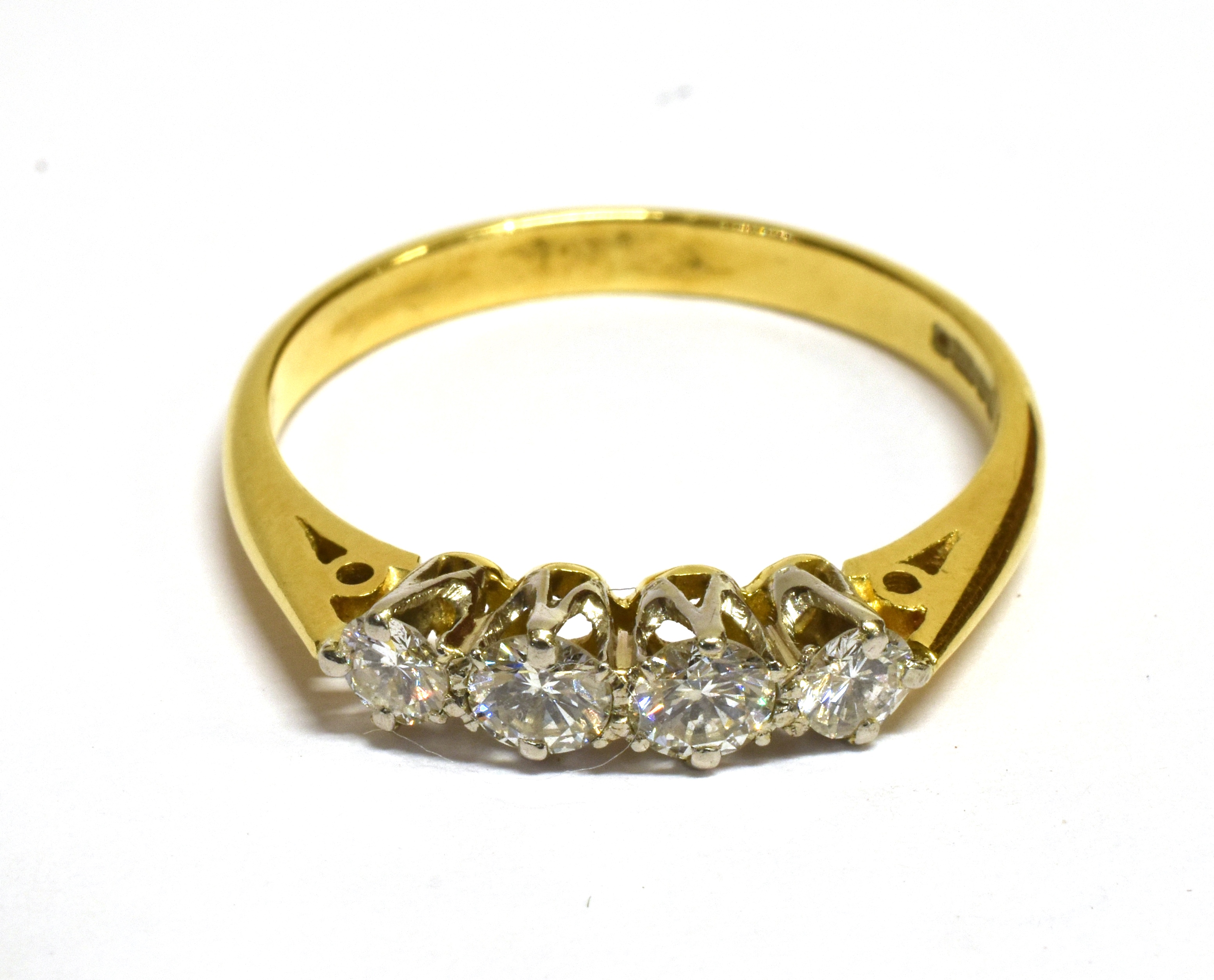 A DIAMOND FOUR STONE RING Four round brilliant cut diamonds with a total diamond weight of approx.