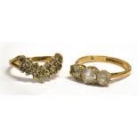TWO 9CT GOLD WHITE STONE SET DRESS RINGS comprising a three stone size N, and a two row wishbone