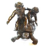 A LARGE BRONZE GROUP MODELLED AS TWO CHILDREN RIDING A TORTOISE 52cm high Condition Report : good