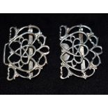 A SILVER NURSES BUCKLE The open work interlocking heart and bow design with scroll boarders,