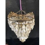 A GILT METAL AND GLASS CEILING LIGHT FITTING with glass drops hanging from six graduated tiers, 28cm