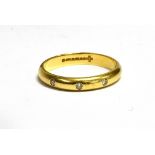 AN 18CT GOLD DIAMOND SET WEDDING BAND the plain D profile ring flash set with three small