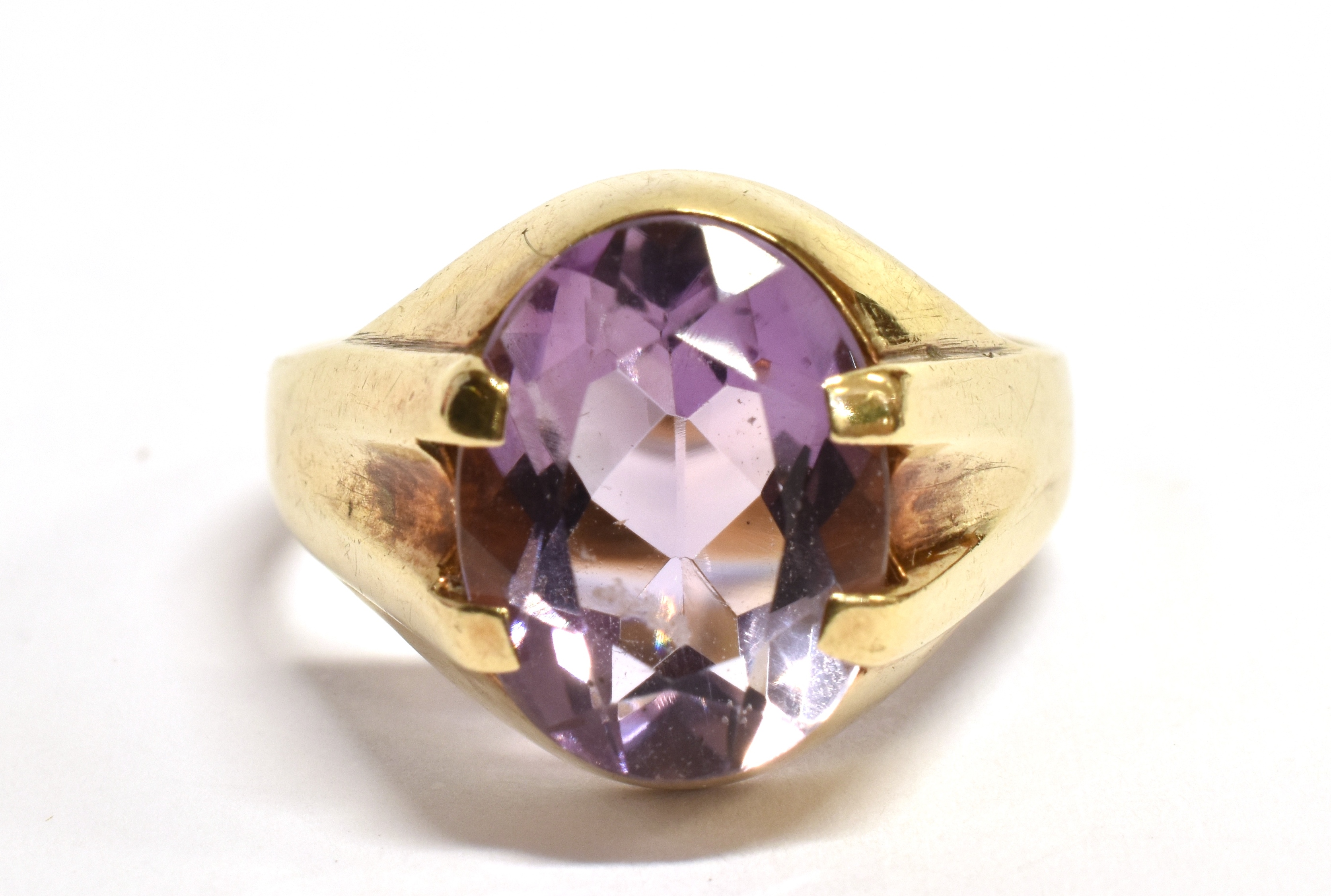 AN AMETHYST SINGLE STONE SIGNET RING The oval cut amethyst approx. 12mm x 9mm, claw set to a