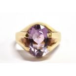 AN AMETHYST SINGLE STONE SIGNET RING The oval cut amethyst approx. 12mm x 9mm, claw set to a