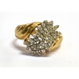 A DIAMOND FANCY CLUSTER 9CT GOLD RING The curved fancy cluster with a total diamond weight of 0.25