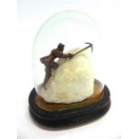 A BRONZED METAL FIGURE OF A MOUNTAINEER in climbing pose, mounted on a block of white quartz,