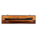 A HALF-HULL MODEL OF A STEAM SHIP late 19th or early 20th century, set to a wall plaque, overall