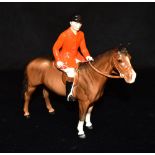 A BESWICK FIGURE OF A HUNTSMAN RIDING A BAY HORSE. 21cm high