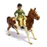 A BESWICK FIGURE OF A YOUNG GIRL ON A COLOURED PONY. Ht 14cm