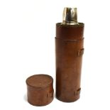 A TALL PLATED FLASK WITH SCREW TOP CUP COVER and contained in a cylindrical leather case, 31cm high