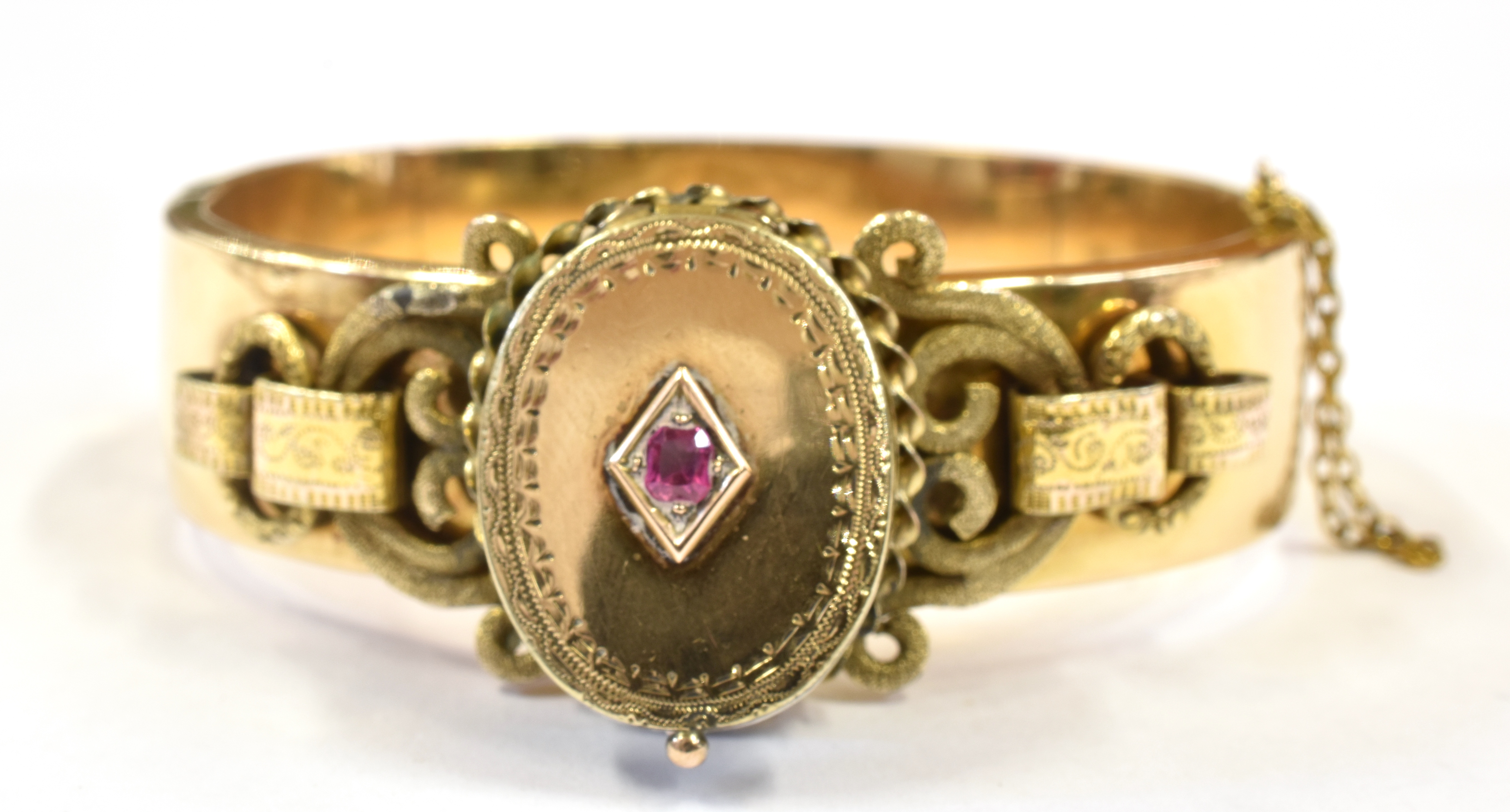 A LATE VICTORIAN BANGLE WITH LOCKET FRONT The oval hinged locket front set with a small ruby to - Image 3 of 3
