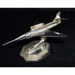 A GALA-SONIC CHROME PLATED TABLE LIGHTER in the form of a jet aeroplane, on adjustable support and