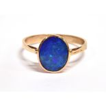 AN OPAL DOUBLET SINGLE STONE SET RING The oval black opal doublet front 10mm x 8mm to a 9ct rose