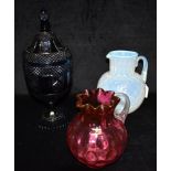 A VICTORIAN BLUE VASELINE GLASS JUG 19.5cm high, cranberry coloured glass jug 16cm high and a