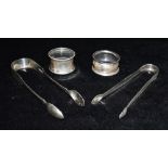 TWO PAIRS OF SILVER SUGAR TONGS AND TWO NAPKIN RINGS the tongs comprising a Victorian Exeter