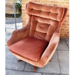 A PARKER KNOLL 'STATESMAN' SWIVEL ARMCHAIR with fabric upholstery, on wooden five prong base