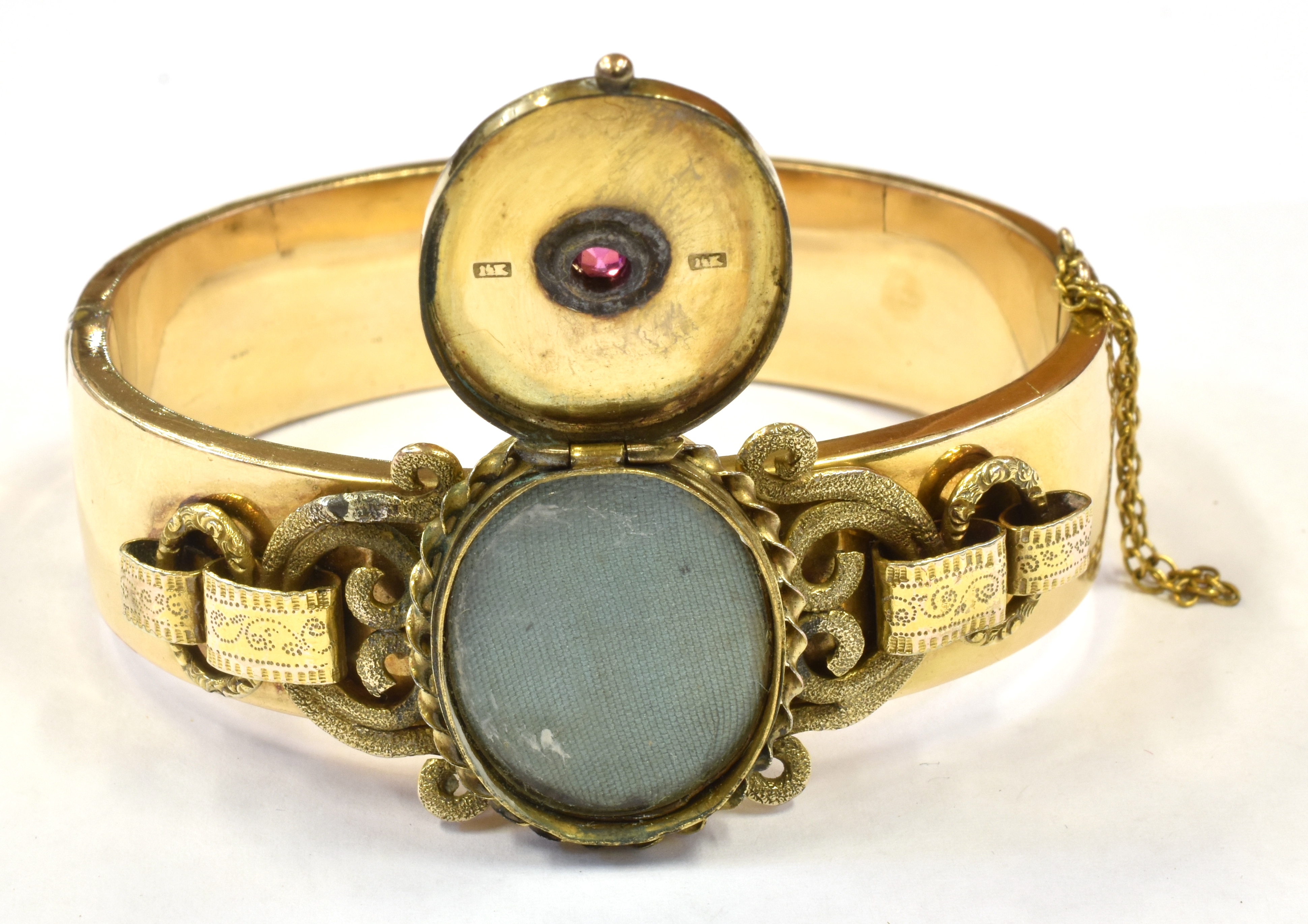 A LATE VICTORIAN BANGLE WITH LOCKET FRONT The oval hinged locket front set with a small ruby to - Image 2 of 3